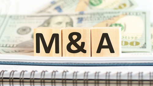M&A Acronyms and Terms. M A short for mergers and acquisitions. Business concept on wooden cubes and dollars